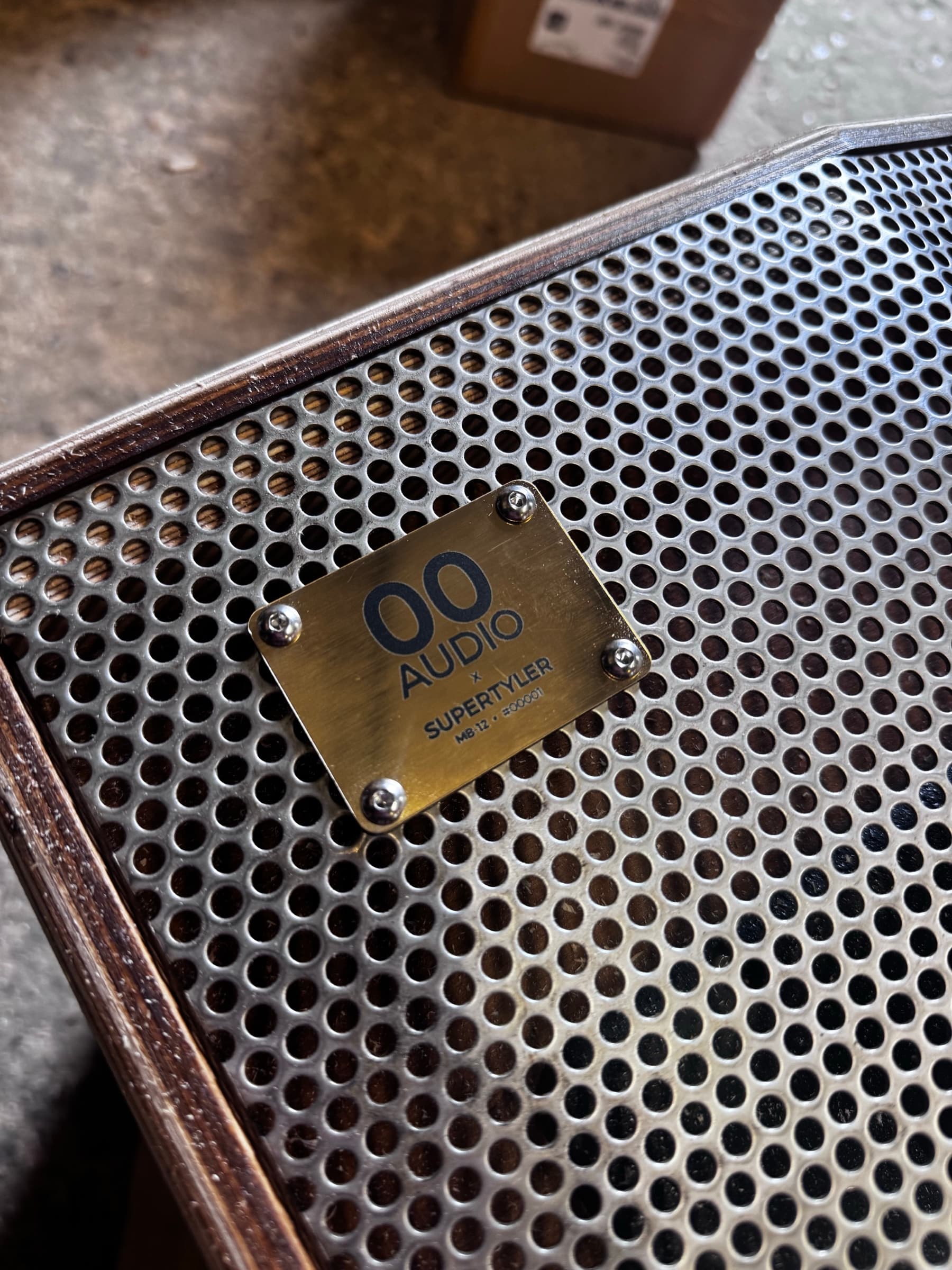 A close-up of a numbered 00 Audio badge