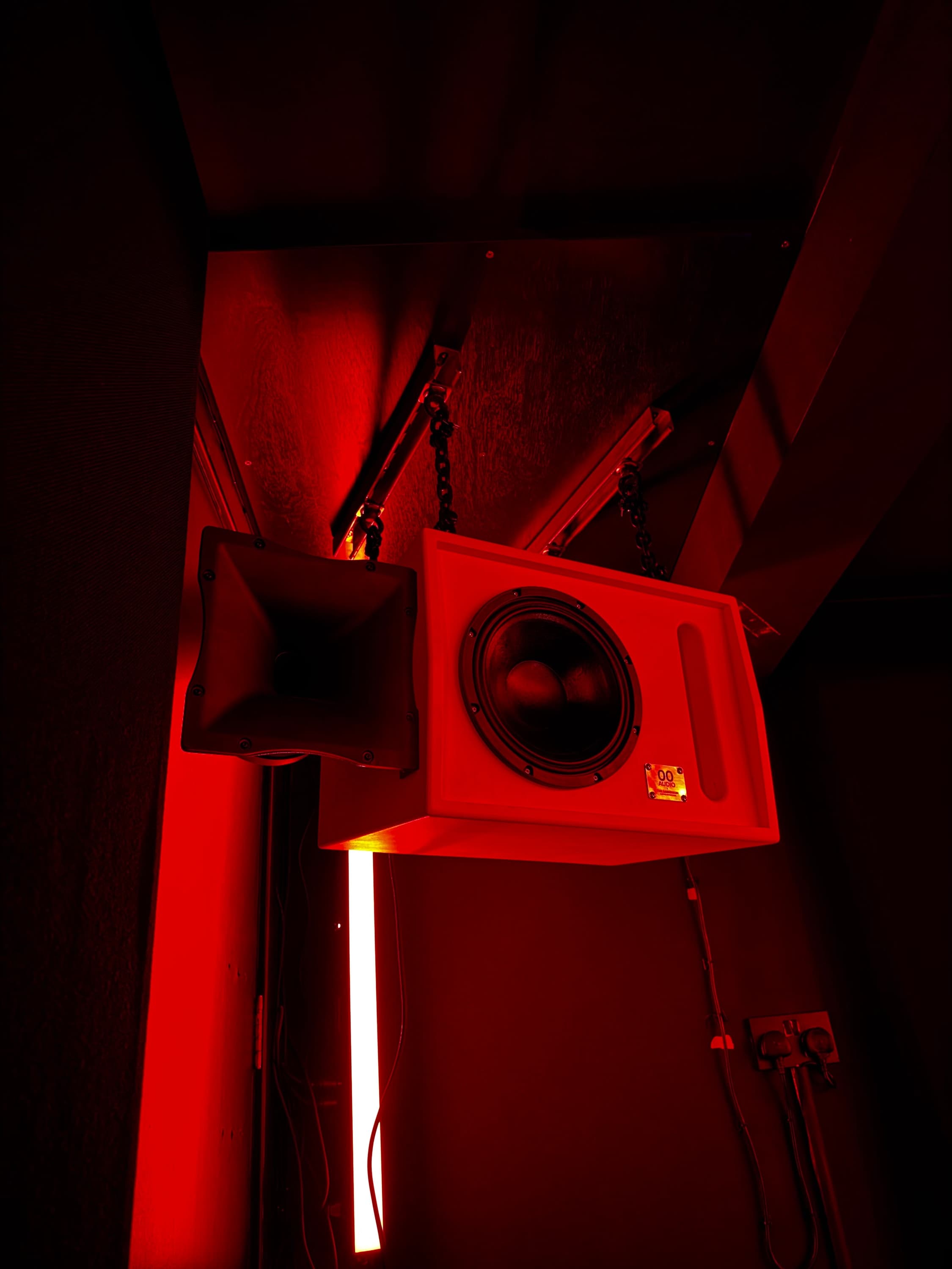 A custom red 00 Audio loudspeaker installed at The Darkroom